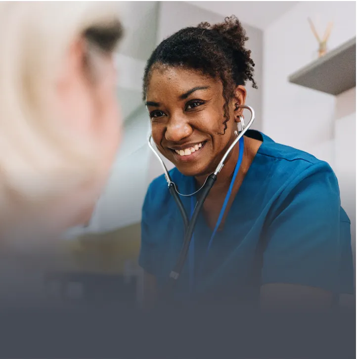 A bedside nurse checking on a patient
