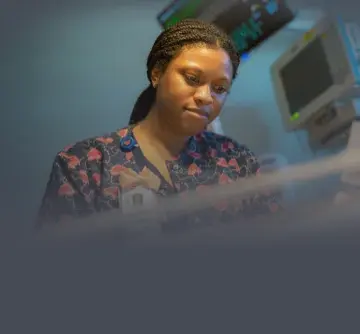 A bedside nurse checking on a patient