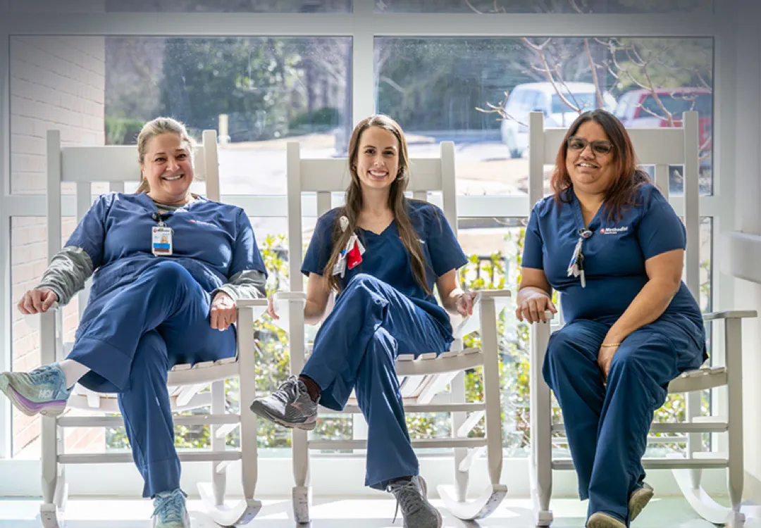 Three coworkers taking a break outside