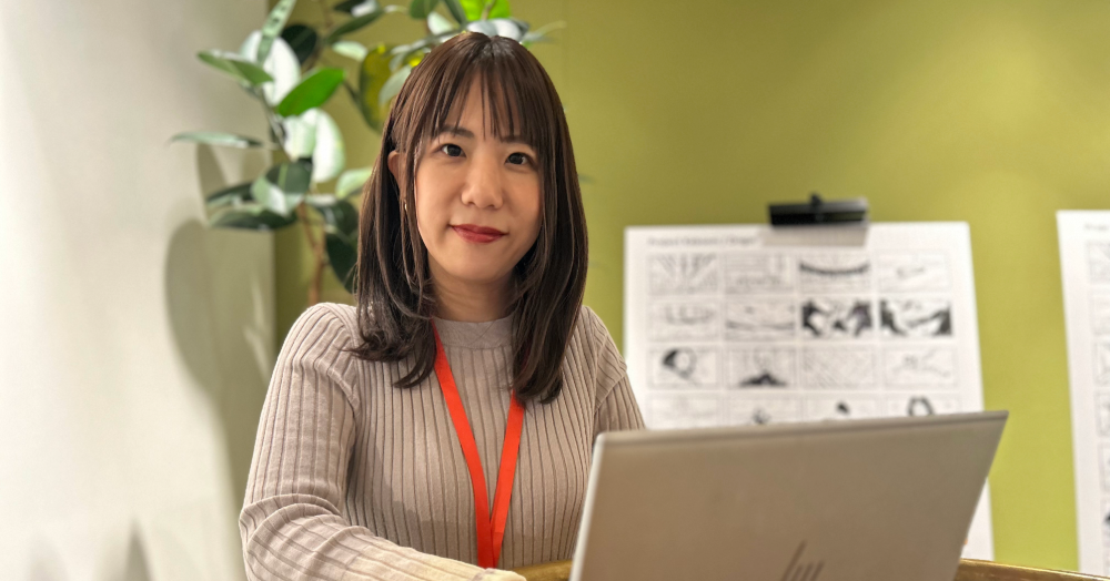 Hitomi at her computer in the office.