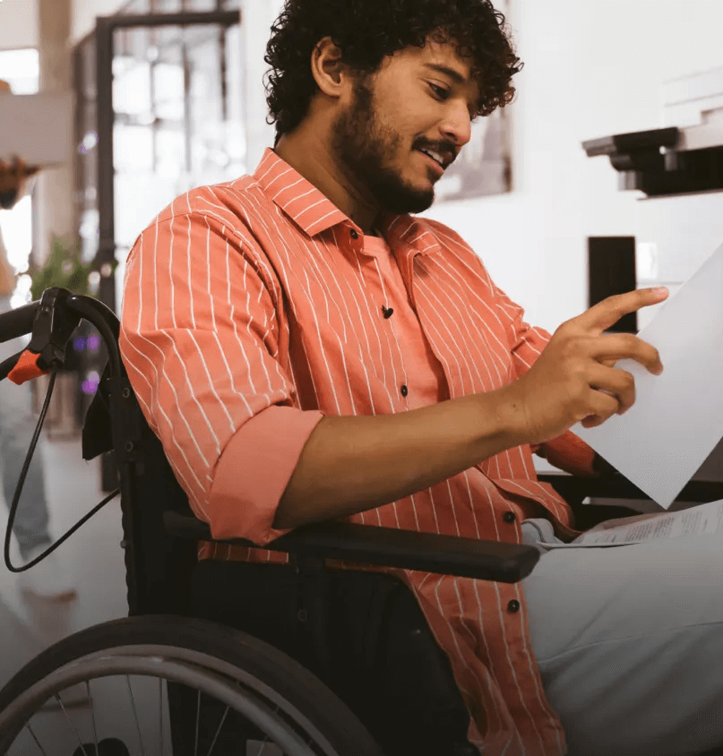 Man in a wheelchair reading a document