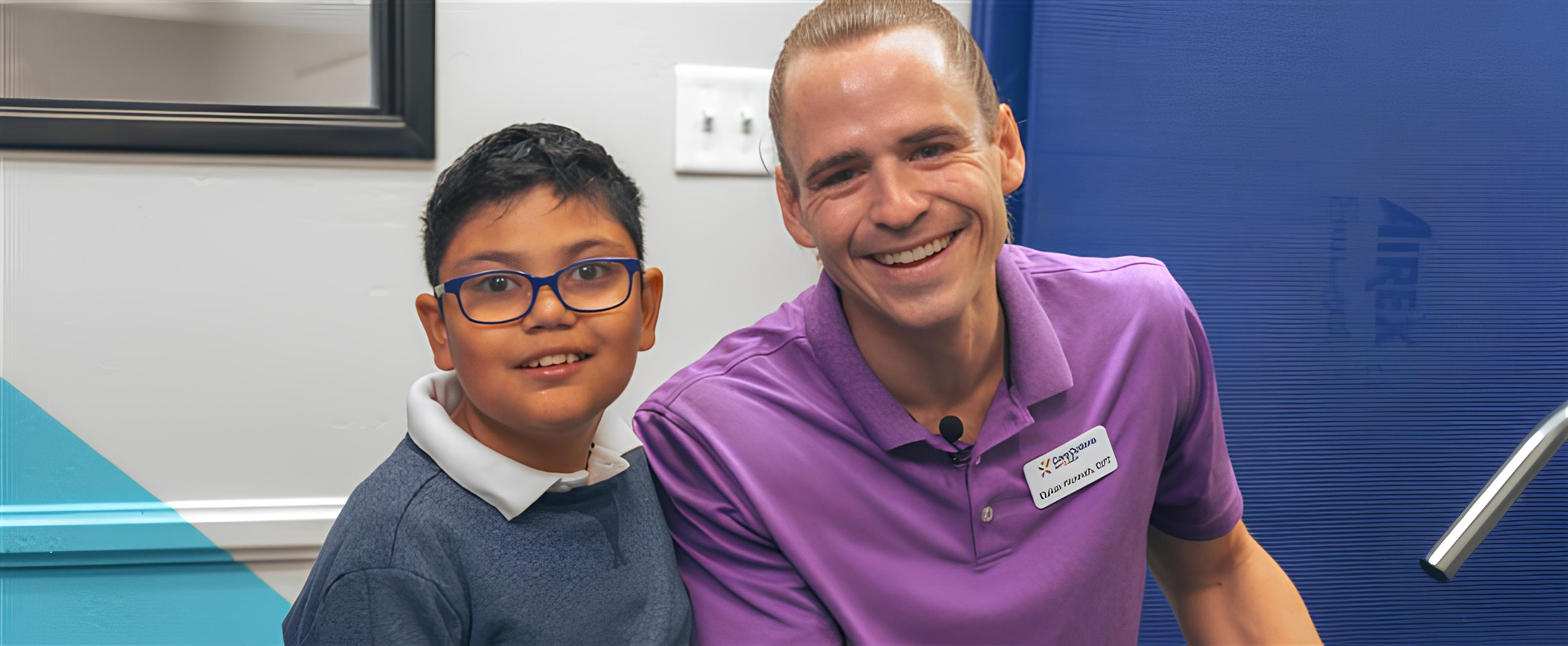 A COFK nurse sits at a table, engaging in play therapy with two children