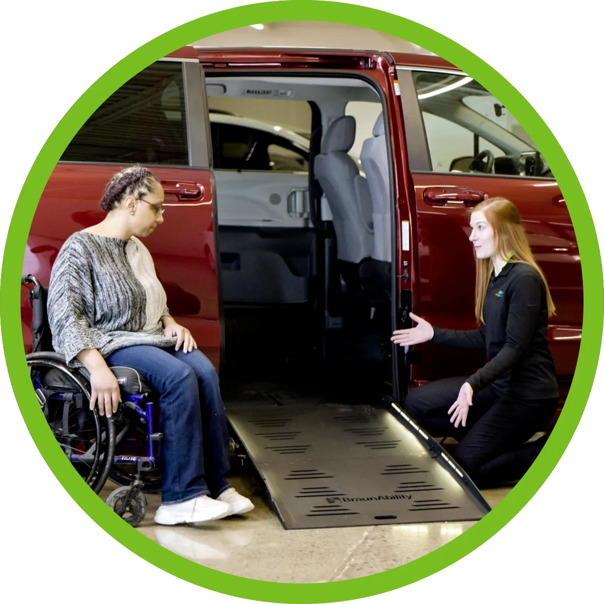 A MobilityWorks general manager assisting a woman in a wheelchair