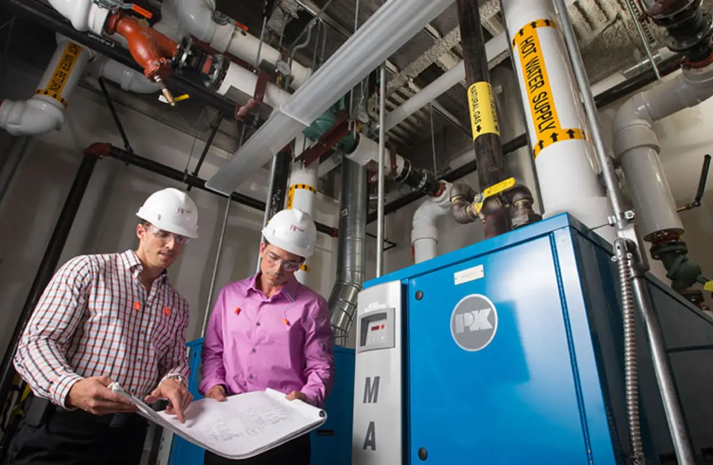 Two male engineers looking at plans