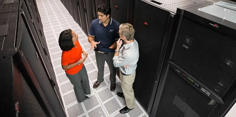 Employees chatting in the server room