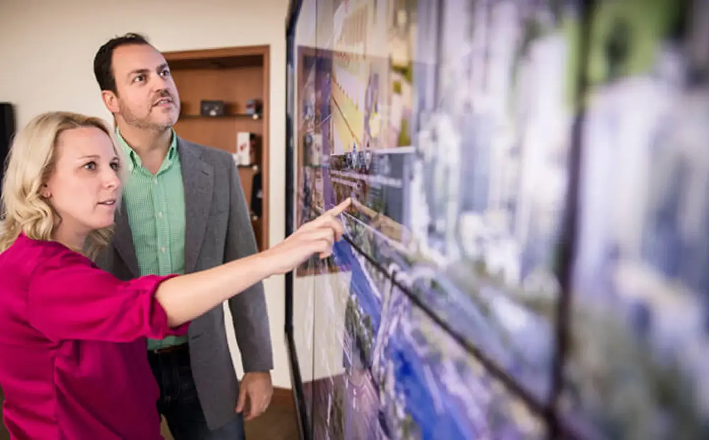 Male and female consultants looking at images on a screen