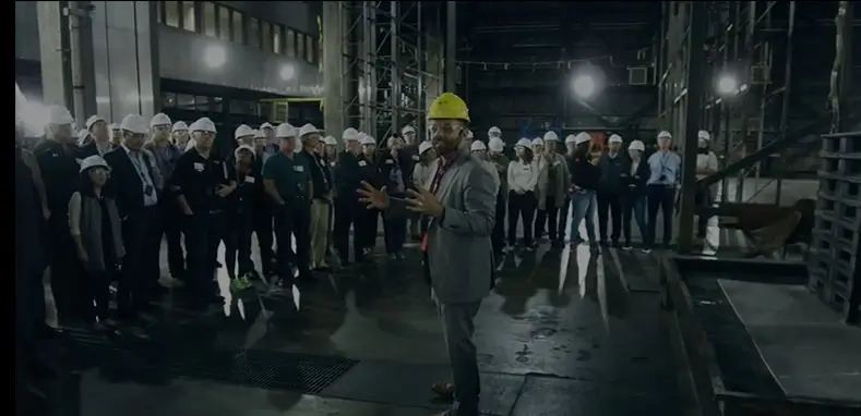 Lead engineer speaking with large team of engineers