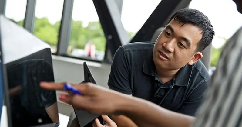 Software engineers looking at a computer screen