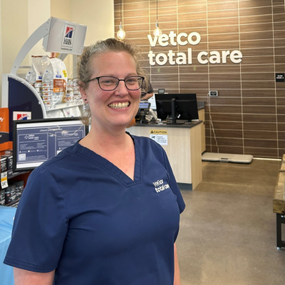 Veterinarian smiling in a Vetco Total Care hospital lobby.