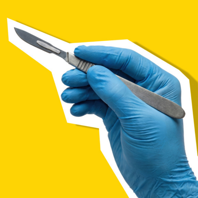 Gloved hand holding a surgical scalpel against a bright yellow background.