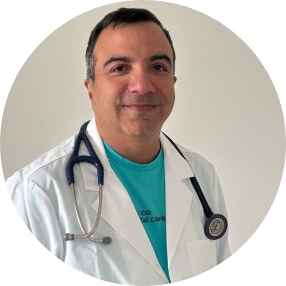 Headshot of Dr. Sepoy smiling in a white coat with a stethoscope.