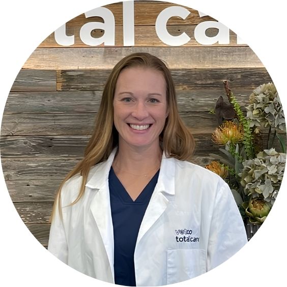 Vetco Total Care veterinarian smiling in a white coat.