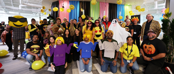 Group in emoji costumes with decorations