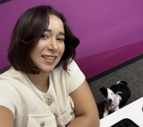 Person at desk with dog nearby
