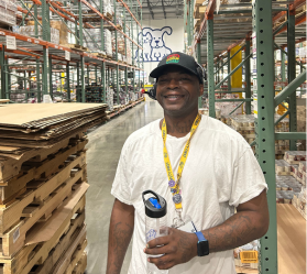 Two people beside forklift in warehouse