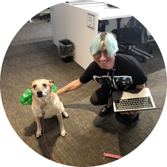 Person petting dog in office setting