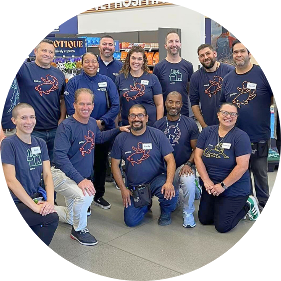 Petco team posing in store with uniforms.