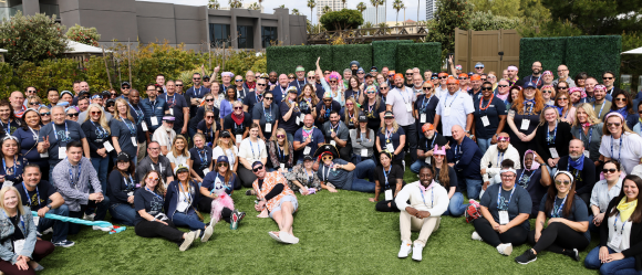 Large group posing outdoors on grass