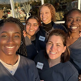 Group of vet assistants posing for a picture outside