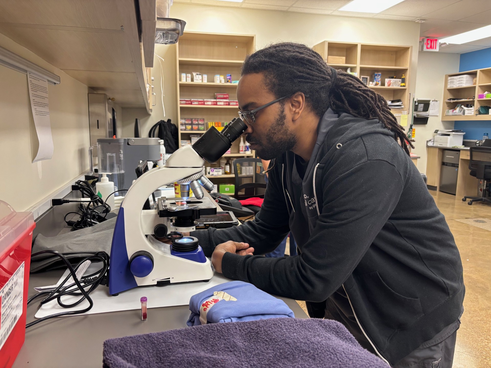 Veterinary Technician using microscope