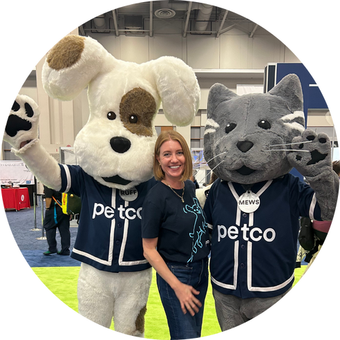 Petco mascots posing at indoor event.