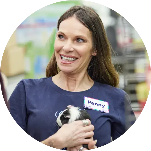 Petco employee holding a guinea pig