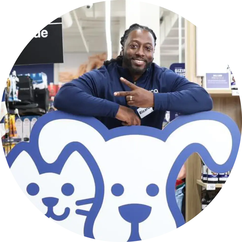Petco employee holding up the peace sign