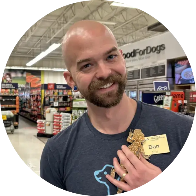 Petco employee holds a lizard in a store