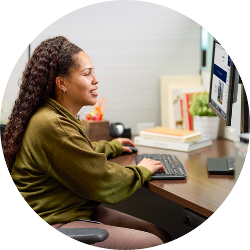 Person working at desk with computer