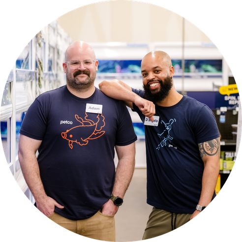 two male petco employees smiling at the camera