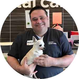 Matt Goeben holding small white dog.