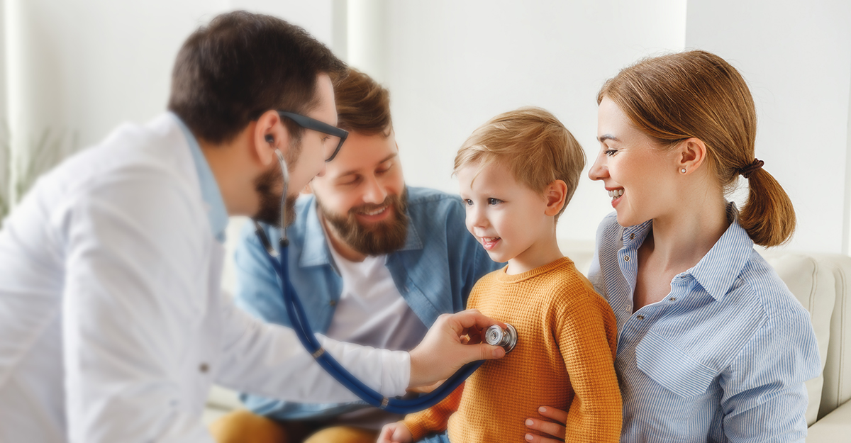 Medical professional using a stethoscope to listen to a child.