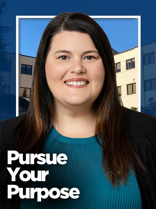 A woman wearing a teal top and black jacket stands in front of a hospital building. Text reads, "Pursue Your Purpose."