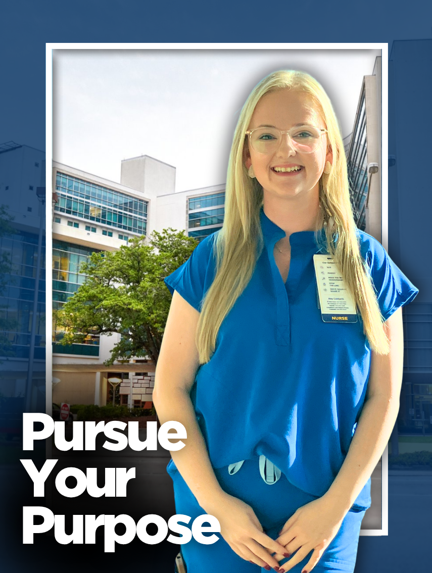 Nurse in blue scrubs standing in front of a hospital building.