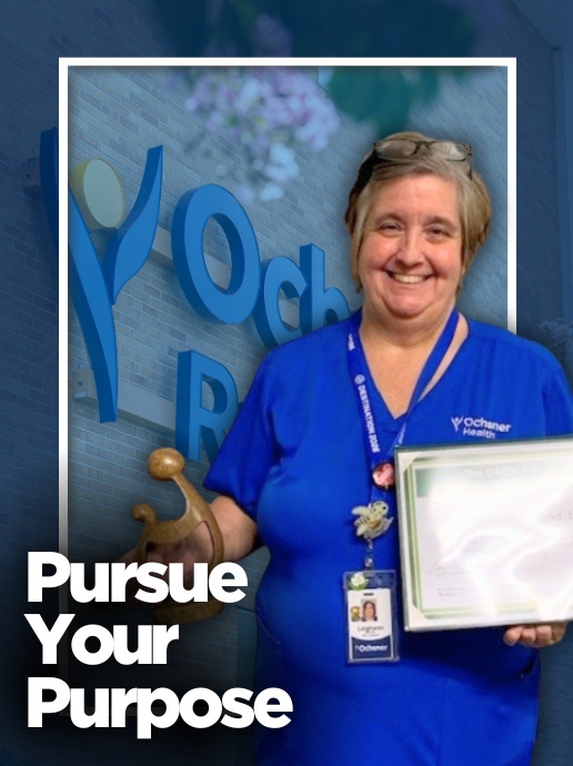 A woman wearing blue medical scrubs holds a framed certificate and award in front of a hospital sign. Text reads, "Pursue Your Purpose.”