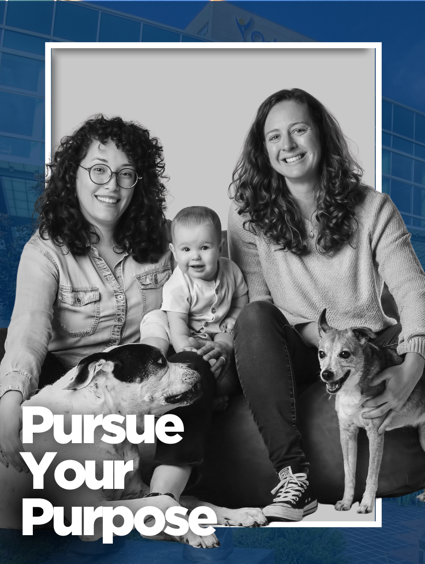 Three people seated together with two dogs in a black-and-white portrait. The image is overlaid with the text “Pursue Your Purpose” and set against a blue-tinted healthcare facility background.