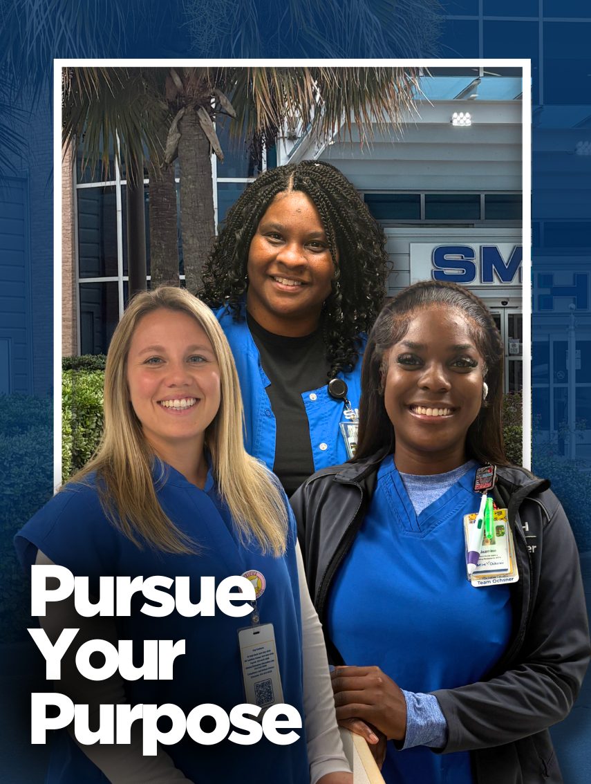 Three smiling female healthcare professionals in blue scrubs stand in front of a modern hospital building with large glass windows and a palm tree. Bold white text at the bottom left reads Pursue Your Purpose.