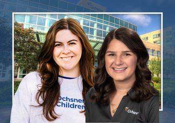 Brunette woman in a white Ochsner Children's sweatshirt and another brunette woman in a dark gray Ochsner polo