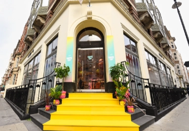 Bright yellow steps leading to Happe Cafe entrance.