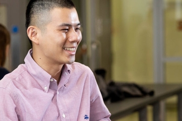 Person smiling in a casual indoor setting.