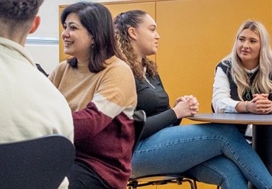 People chatting and smiling in a modern office space.
