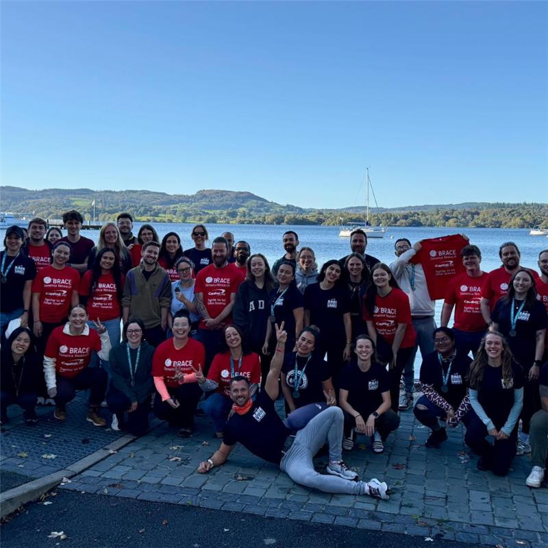 Group of participants by the lake after the charity race.