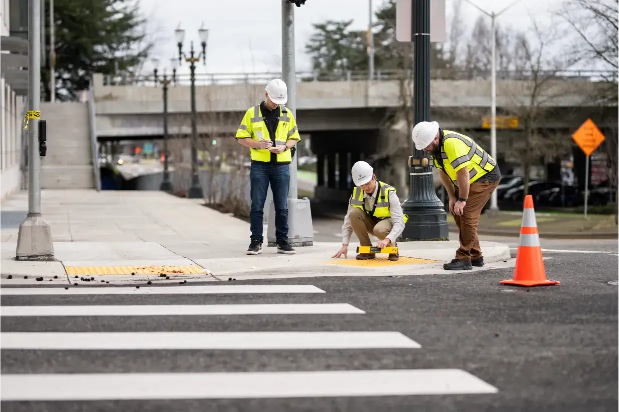 three employees working on corner street