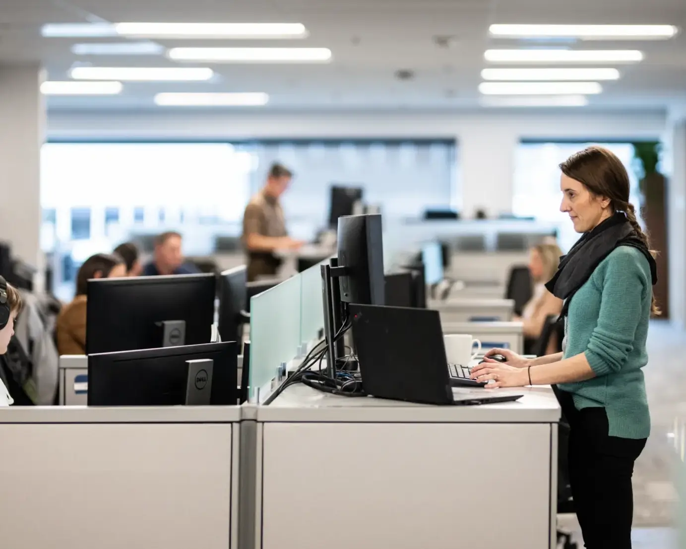 Employee working at standing desk in office