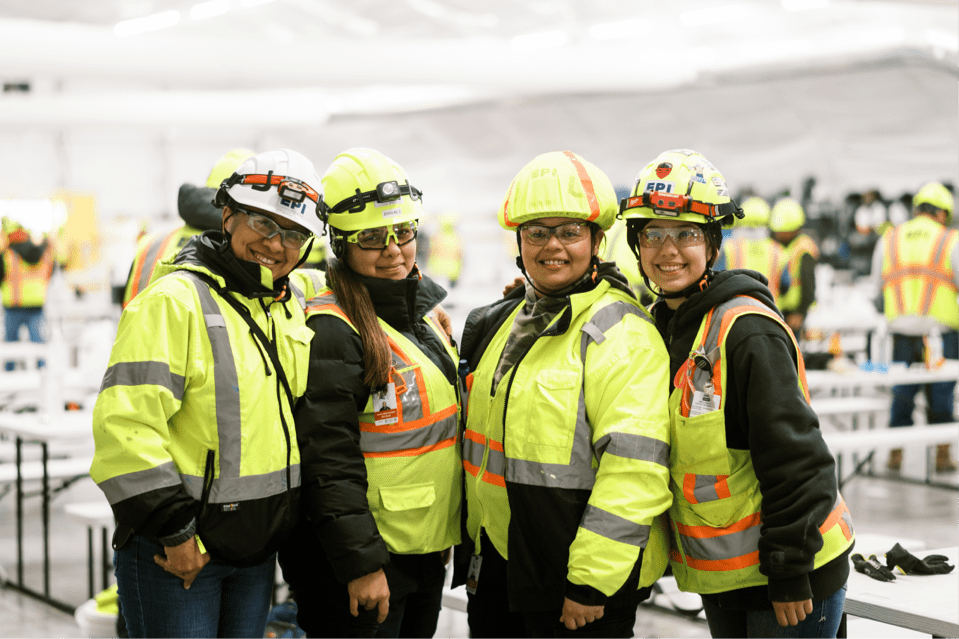 Happy workers in protective equipment representing company culture
