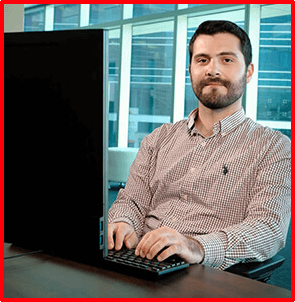 employee sitting at desk and working on his computer