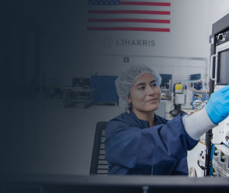 people in an office, one pointing at a screen.