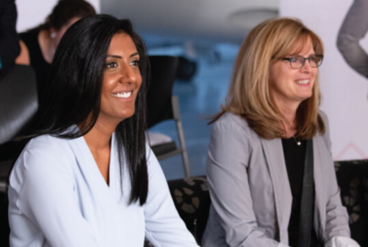 Two woman smiling