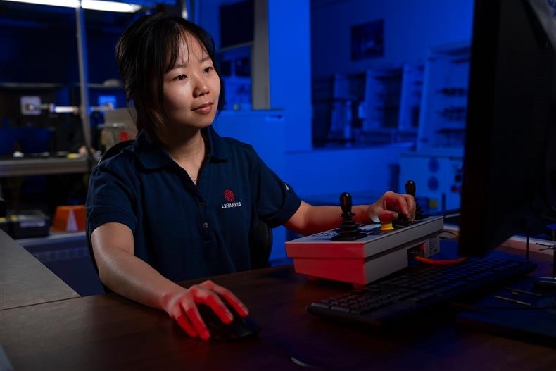 Engineer inspecting yellow and black machinery.