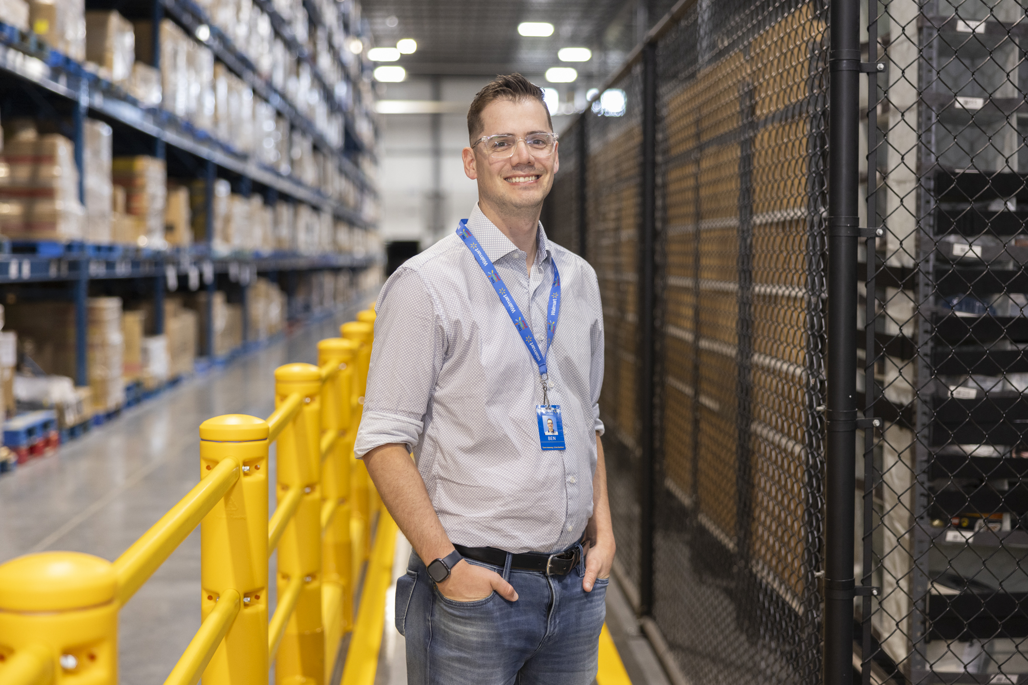 person in front of boxes of products smiling